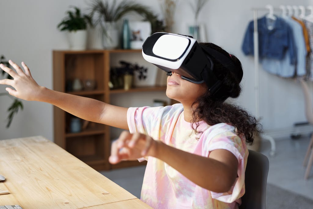 A teenage girl fully immersed in a virtual reality game while sitting in a cozy indoor setting.